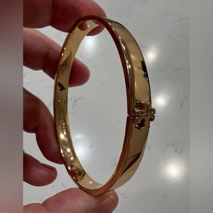 Gold Tory Burch snap bracelet.
